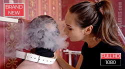 Lady Iveta breathes smoke lazily into her slave's face